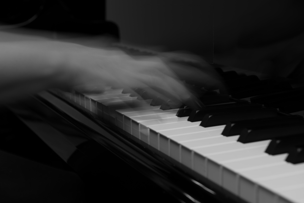 Background image of 2 moving hands playing piano
